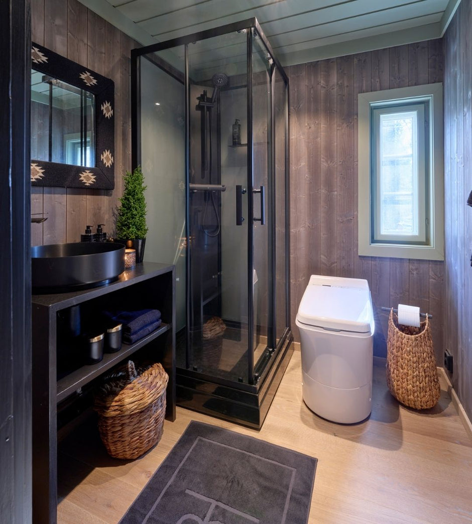 Bathroom with shower, a Cinderella Comfort toilet, and shelves against a wooden wall.