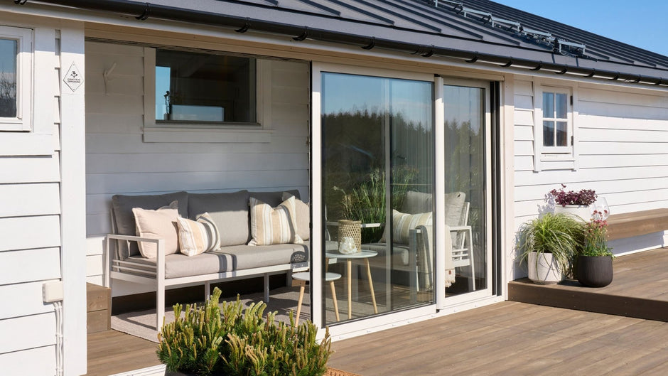 Modern patio with outdoor furniture and sliding glass door.