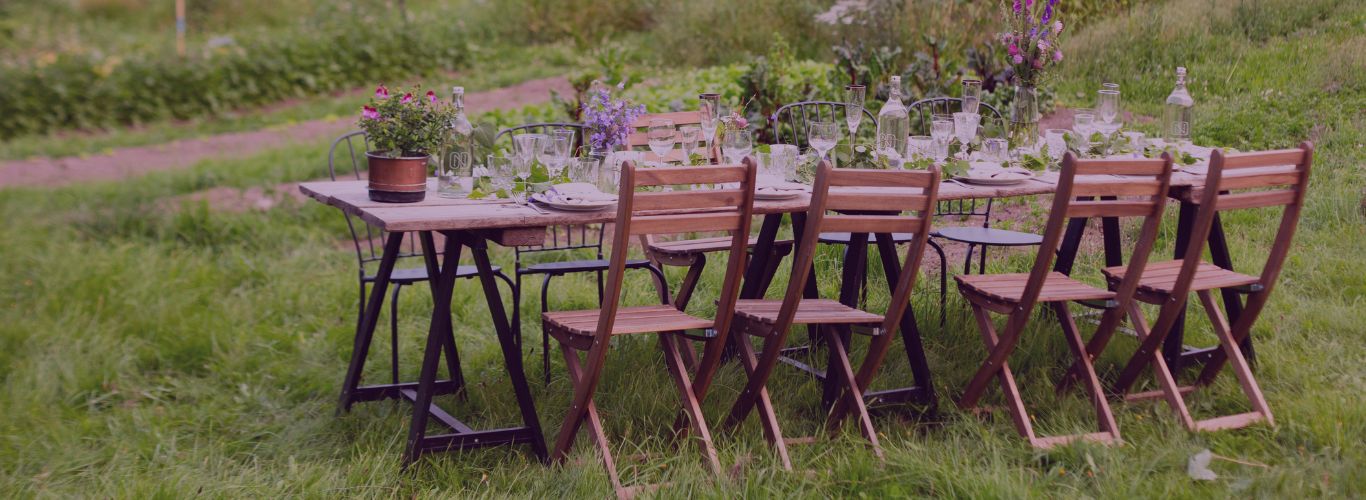 Outdoor setting with a table and chairs on a grassy field
